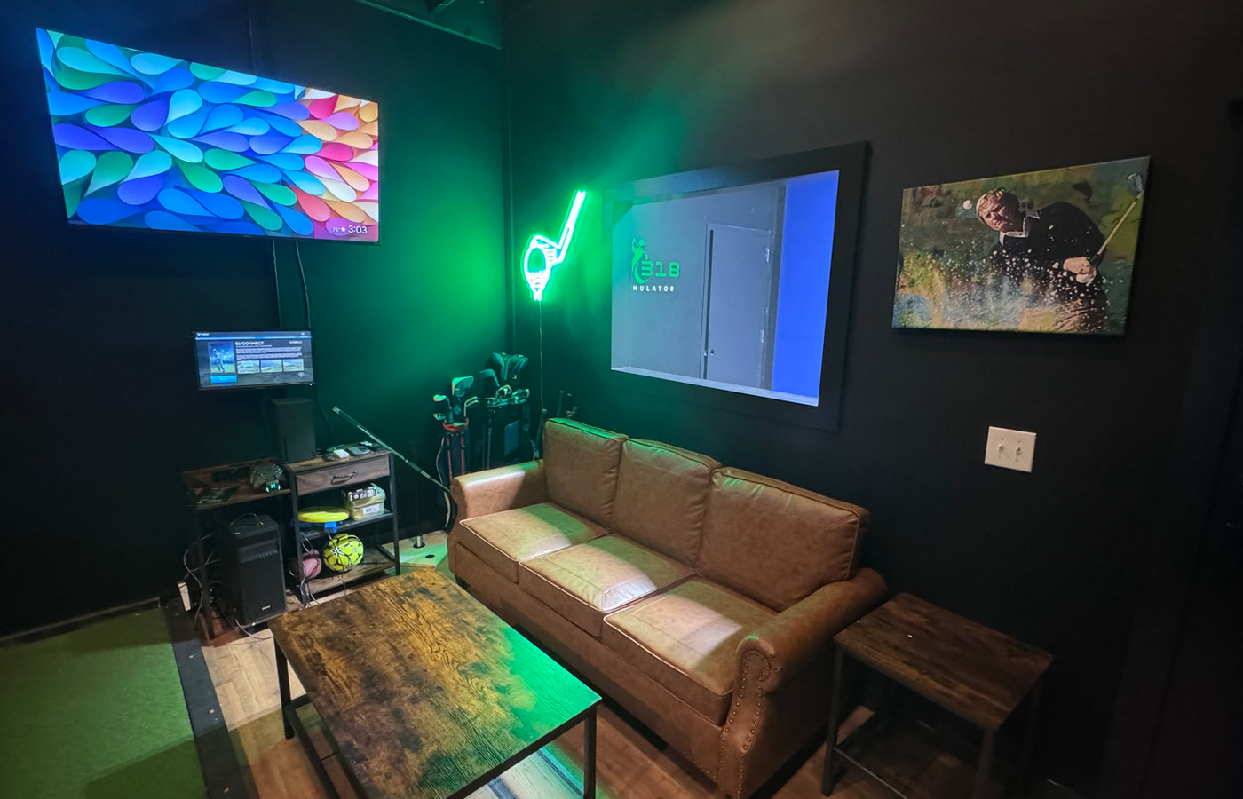 Neon-lit lounge seating and big-screen TV inside a Golf318 bay